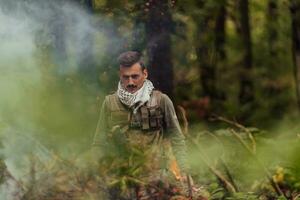 A modern warfare soldier on war duty in dense and dangerous forest areas. Dangerous military rescue operations photo