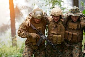 military squad in action rescue wounded soldier photo