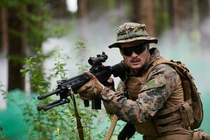 soldier in action aiming  on weapon  laser sight optics photo