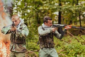 Angry terrorist militant guerrilla soldier warrior in forest photo