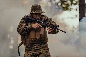 A soldier fights in a warforest area surrounded by fire photo