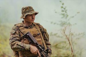 A soldier fights in a warforest area surrounded by fire photo