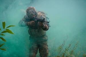 soldier in action aiming  on weapon  laser sight optics photo