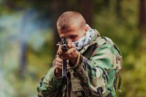 Angry terrorist militant guerrilla soldier warrior in forest photo