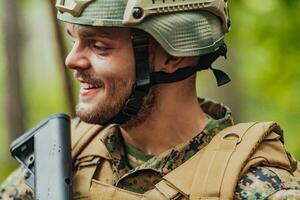 A modern warfare soldier on war duty in dense and dangerous forest areas. Dangerous military rescue operations photo
