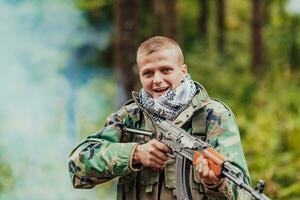 Angry terrorist militant guerrilla soldier warrior in forest photo