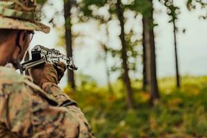 A modern warfare soldier on war duty in dense and dangerous forest areas. Dangerous military rescue operations photo