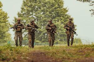 Soldier fighters standing together with guns. Group portrait of US army elite members, private military company servicemen, anti terrorist squad photo