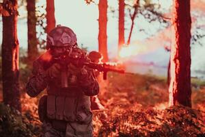 A soldier fights in a warforest area surrounded by fire photo