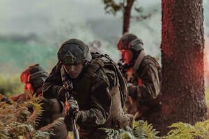 A group of modern warfare soldiers is fighting a war in dangerous remote forest areas. A group of soldiers is fighting on the enemy line with modern weapons. The concept of warfare and military conflicts photo