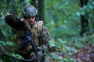 soldier preparing tactical and commpunication gear for action battle photo