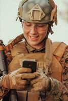 Soldier using smartphone to contact family or girlfriend communication and nostalgia concept photo
