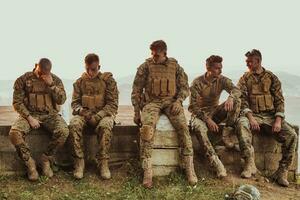 Soldiers squad relaxing after battle having a break on training photo