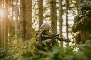 A group of modern warfare soldiers is fighting a war in dangerous remote forest areas. A group of soldiers is fighting on the enemy line with modern weapons. The concept of warfare and military conflicts photo