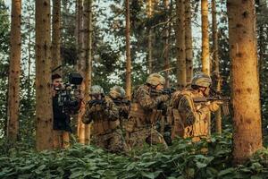 Videographer with Professional Movie Video Camera Gimbal Stabilizing Equipment Taking Action Shoot of Soldiers in Action in Forest photo