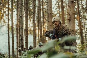 A group of modern warfare soldiers is fighting a war in dangerous remote forest areas. A group of soldiers is fighting on the enemy line with modern weapons. The concept of warfare and military conflicts photo