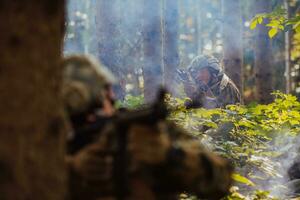 A group of modern warfare soldiers is fighting a war in dangerous remote forest areas. A group of soldiers is fighting on the enemy line with modern weapons. The concept of warfare and military conflicts photo