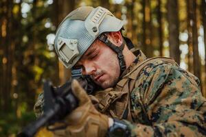 A modern warfare soldier on war duty in dense and dangerous forest areas. Dangerous military rescue operations photo