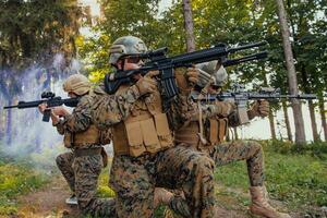 Soldier fighters standing together with guns. Group portrait of US army elite members, private military company servicemen, anti terrorist squad photo