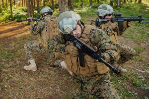 Soldier fighters standing together with guns. Group portrait of US army elite members, private military company servicemen, anti terrorist squad photo