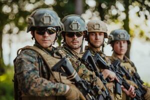 Soldier fighters standing together with guns. Group portrait of US army elite members, private military company servicemen, anti terrorist squad photo