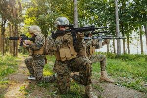 Soldier fighters standing together with guns. Group portrait of US army elite members, private military company servicemen, anti terrorist squad photo