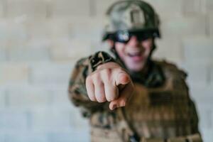 I choose you. A soldier with an outstretched hand towards the camera shows that he chooses you for support and partnership in warfare photo