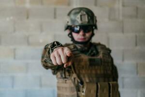 I choose you. A soldier with an outstretched hand towards the camera shows that he chooses you for support and partnership in warfare photo