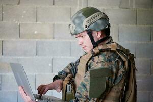 soldier using laptop computer photo