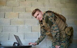 soldier using laptop computer photo