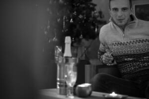 Happy young man with a glass of champagne photo