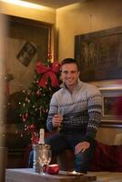 Happy young man with a glass of champagne photo