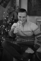 Happy young man with a glass of champagne photo