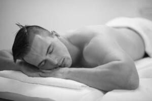 handsome man resting in a spa massage center photo