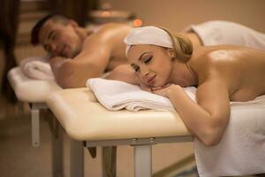 young couple lying on massage table photo