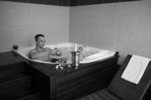 man relaxing in the jacuzzi photo