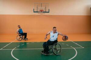 disabled war veterans in action while playing basketball on a basketball court with professional sports equipment for the disabled photo
