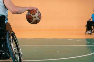 Close up photo of wheelchairs and handicapped war veterans playing basketball on the court