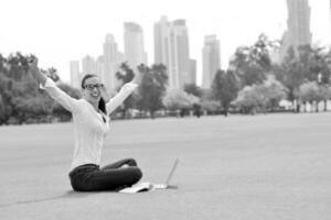 woman with laptop in park photo