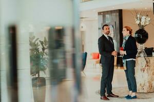 Photo of a businessman and businesswoman discussing business projects in a modern corporation. Selective focus