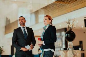 Photo of a businessman and businesswoman discussing business projects in a modern corporation. Selective focus