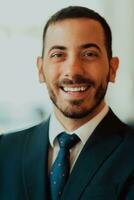 Portrait of a businessman in a suit in a modern office building. Selective focus photo