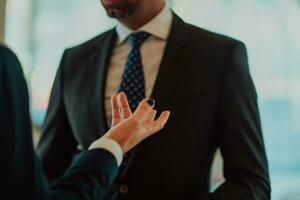 Photo of a businessman and businesswoman discussing business projects in a modern corporation. Selective focus