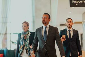 Photo of a business team in suits walking in a modern corporation. Successful business team. Selective focus