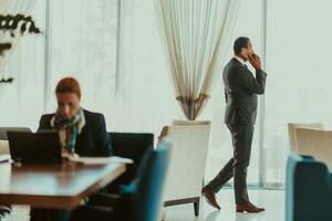 Photo of a businessman in a modern company using a smartphone. Selective focus