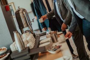 Close-up photo of businessmen serving themselves in a modern hotel during a dinner party. Selective focus