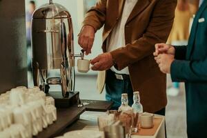 Close-up photo of businessmen serving themselves in a modern hotel during a dinner party. Selective focus