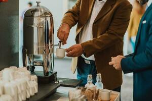 Close-up photo of businessmen serving themselves in a modern hotel during a dinner party. Selective focus