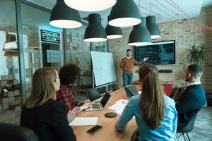 Leader give a business presentation at an office conference meeting, businessman coach mentor explains graph chart on board corporate group workshop training in boardroom. Selective focus photo