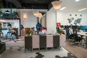 Group of casual multiethnic business people taking break from the work doing different things while enjoying free time in relaxation area at modern open plan startup office photo